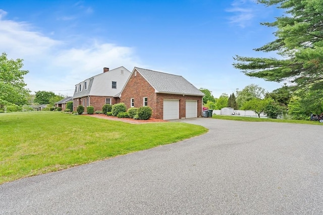 20 Highwood Way, North Andover, MA 01845 - view of side of home featuring brick siding, a garage, a lawn, and driveway