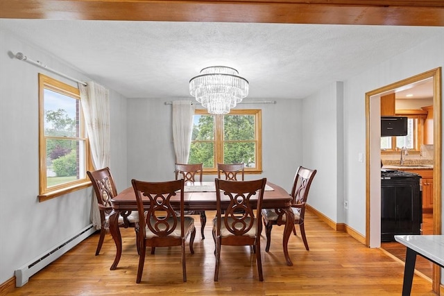20 Highwood Way, North Andover, MA 01845 - dining room with a baseboard heating unit, a chandelier, light wood-style flooring, and baseboards
