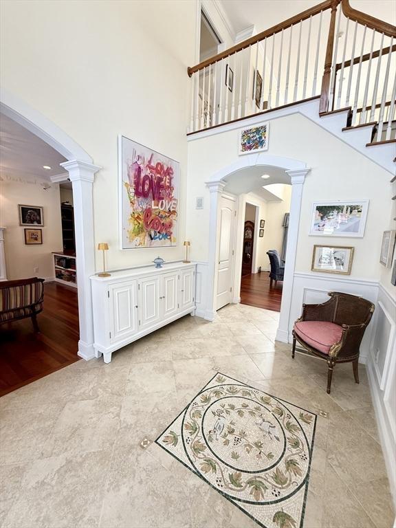 entrance foyer with a towering ceiling and decorative columns