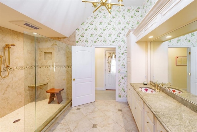 bathroom with vanity and tiled shower