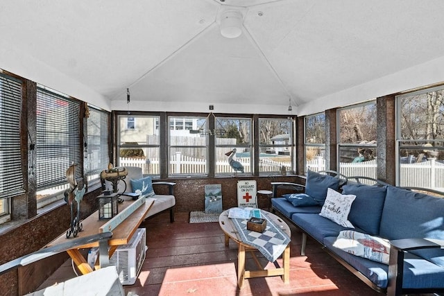 sunroom / solarium featuring lofted ceiling