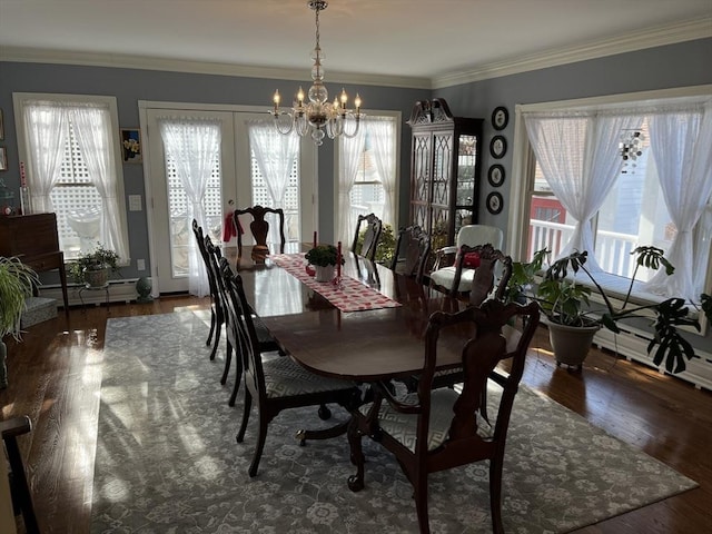 dining area with a healthy amount of sunlight, dark hardwood / wood-style floors, and a chandelier