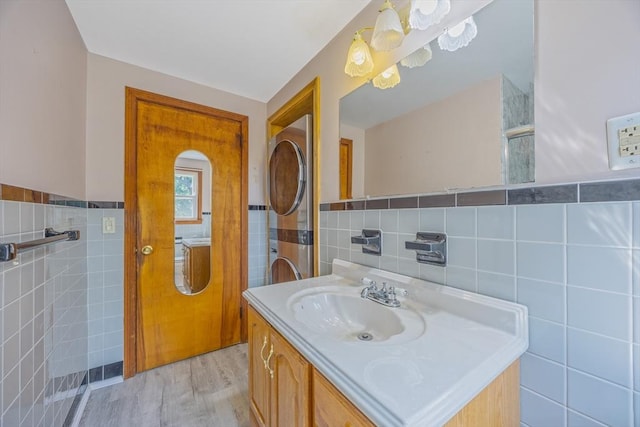 121 Donlyn Dr, Chicopee, MA 01013 - bathroom with tile walls, vanity, wood finished floors, and a wainscoted wall