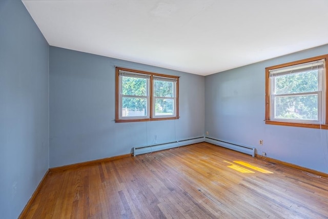 121 Donlyn Dr, Chicopee, MA 01013 - empty room with hardwood / wood-style floors, healthy amount of natural light, and baseboard heating