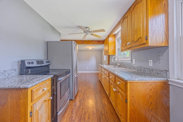 121 Donlyn Dr, Chicopee, MA 01013 - kitchen with stainless steel range with electric cooktop, wood finished floors, a ceiling fan, and brown cabinets