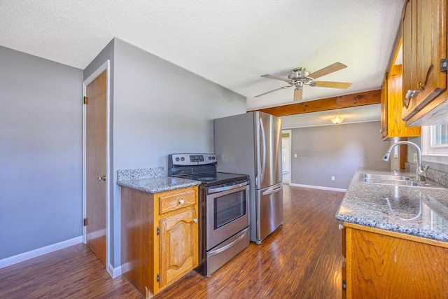 121 Donlyn Dr, Chicopee, MA 01013 - kitchen with appliances with stainless steel finishes, dark wood finished floors, brown cabinets, ceiling fan, and a textured ceiling