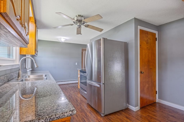 121 Donlyn Dr, Chicopee, MA 01013 - kitchen featuring appliances with stainless steel finishes, dark wood-style flooring, a ceiling fan, baseboard heating, and a textured ceiling
