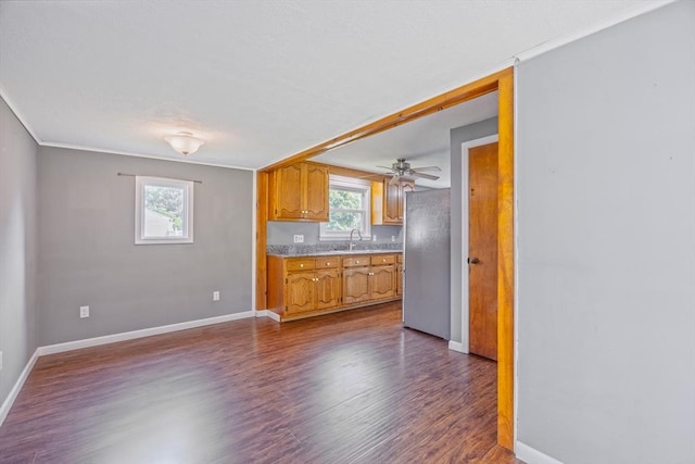 121 Donlyn Dr, Chicopee, MA 01013 - kitchen featuring freestanding refrigerator, dark wood-type flooring, light countertops, ceiling fan, and brown cabinetry