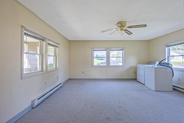 121 Donlyn Dr, Chicopee, MA 01013 - laundry room featuring baseboard heating, washing machine and clothes dryer, light carpet, a ceiling fan, and a textured ceiling