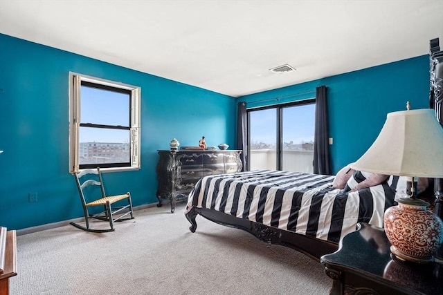 carpeted bedroom featuring visible vents and baseboards