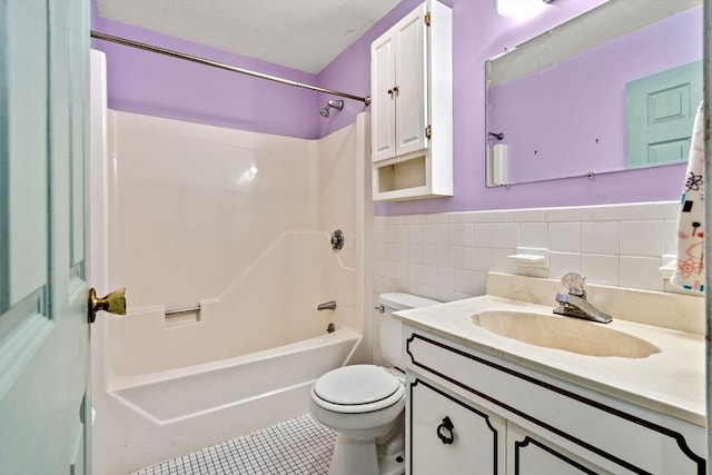 full bath with toilet, shower / washtub combination, tile walls, tile patterned flooring, and vanity