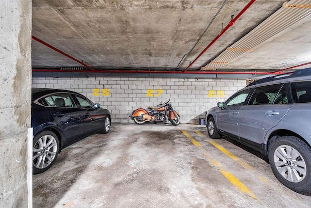 parking deck featuring concrete block wall