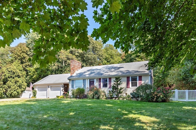 view of front of house with a garage and a front lawn