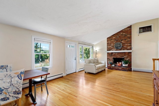 living room with light hardwood / wood-style floors, lofted ceiling, a fireplace, and baseboard heating