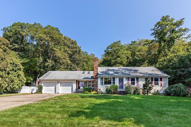 ranch-style house featuring a garage and a front lawn