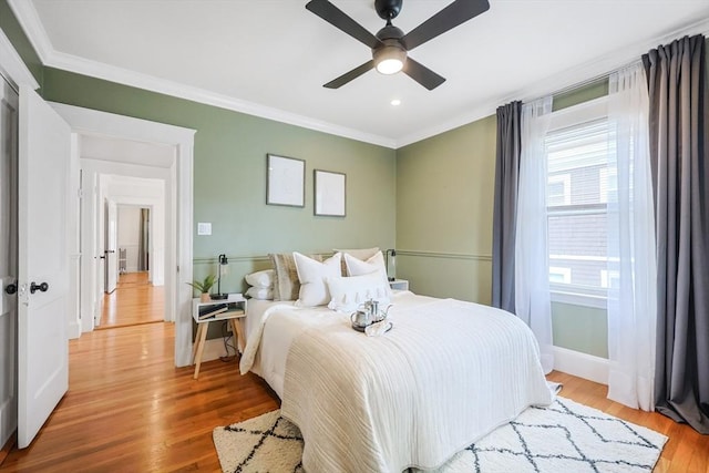 bedroom featuring ornamental molding, light wood-style floors, baseboards, a ceiling fan, and recessed lighting