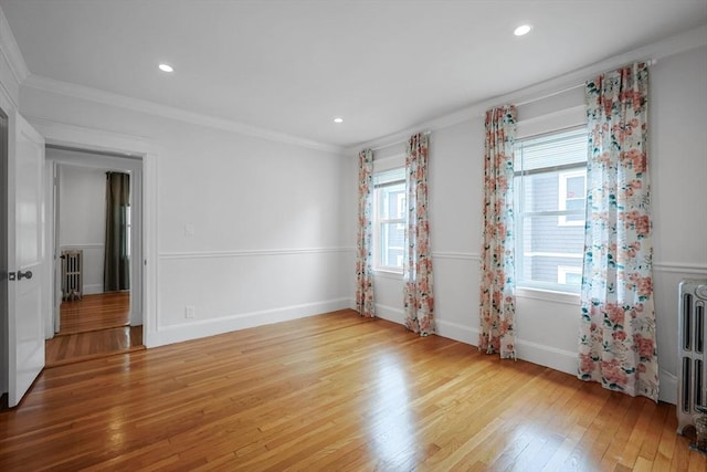 spare room featuring light wood-style flooring, ornamental molding, recessed lighting, and baseboards