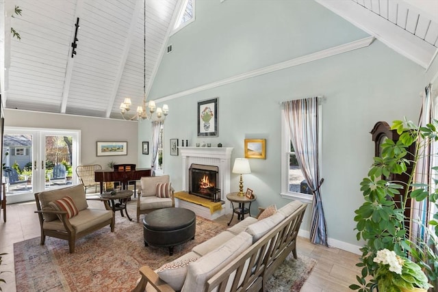 11 White Oak Trl, Barnstable, MA 02632 - living room with high vaulted ceiling, a chandelier, track lighting, baseboards, and a warm lit fireplace