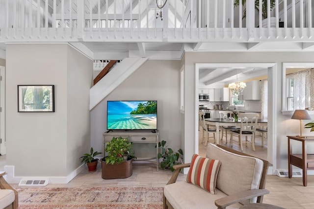 11 White Oak Trl, Barnstable, MA 02632 - living room with a chandelier, a towering ceiling, baseboards, and beam ceiling