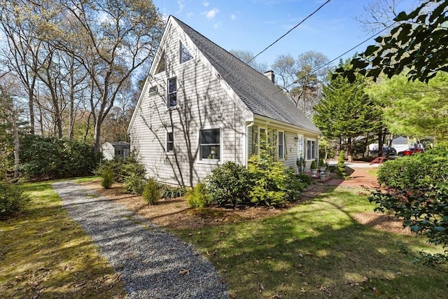 11 White Oak Trl, Barnstable, MA 02632 - view of side of home with a chimney, roof with shingles, and a yard