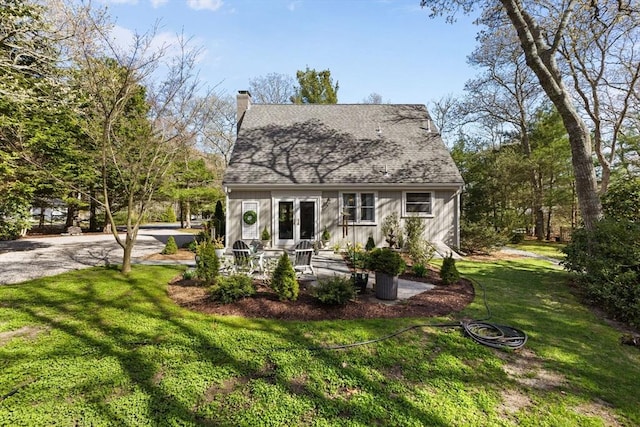 11 White Oak Trl, Barnstable, MA 02632 - rear view of house with french doors, board and batten siding, a yard, a chimney, and a shingled roof
