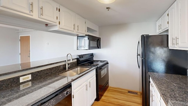 kitchen featuring black appliances, white cabinetry, and sink