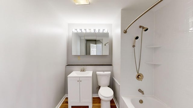 full bathroom featuring bathtub / shower combination, vanity, hardwood / wood-style flooring, and toilet