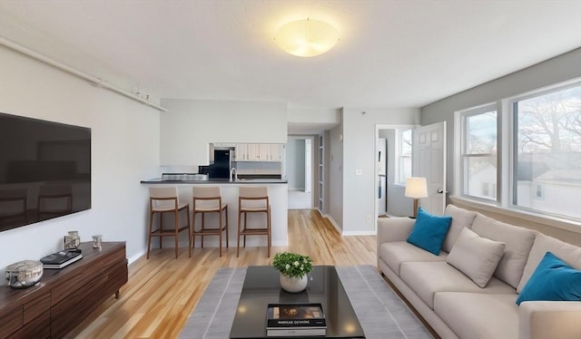 living room featuring sink and light wood-type flooring