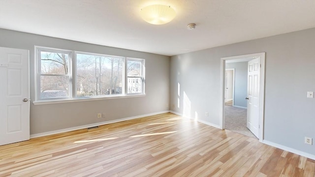 spare room with light hardwood / wood-style flooring