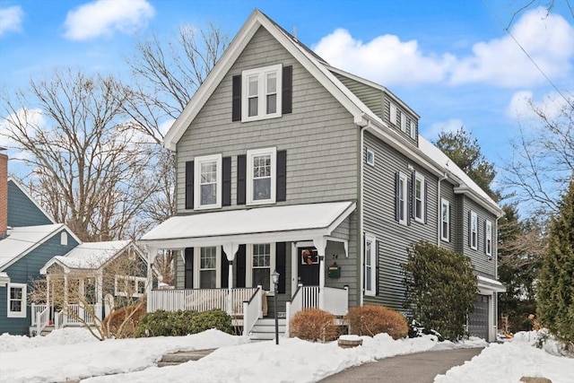 view of front facade featuring covered porch and a garage