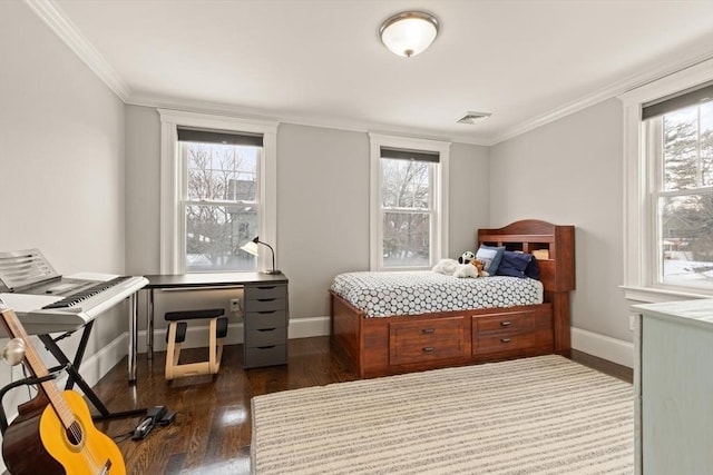 bedroom with multiple windows, dark wood finished floors, and visible vents