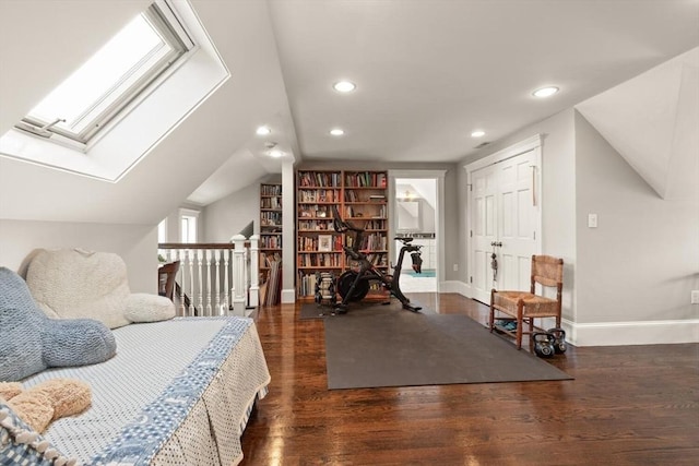 bedroom featuring vaulted ceiling with skylight, dark wood finished floors, baseboards, and recessed lighting