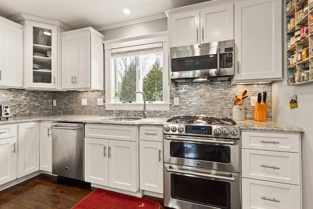 kitchen with white cabinets, glass insert cabinets, and stainless steel appliances