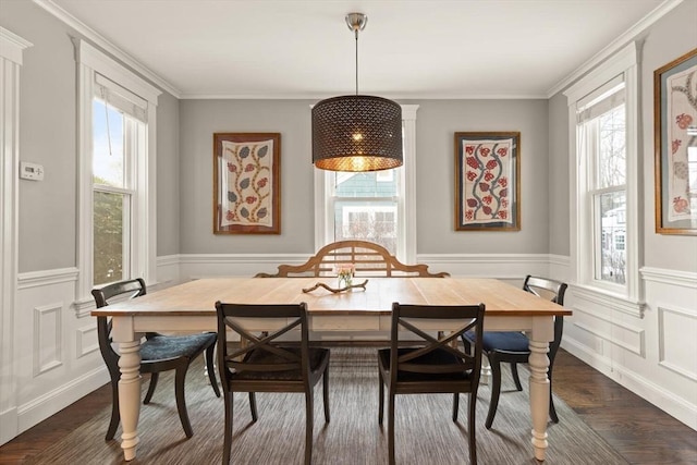 dining room featuring dark wood-style flooring, wainscoting, and plenty of natural light