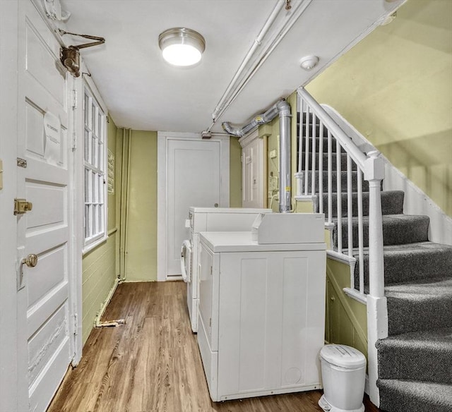 clothes washing area featuring washer and dryer and light wood-type flooring