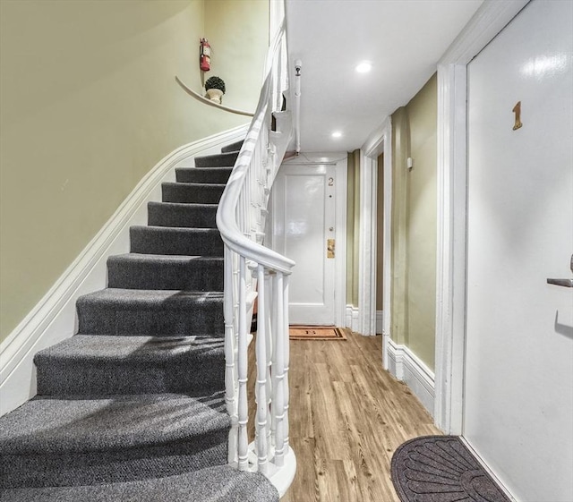 stairway featuring hardwood / wood-style floors