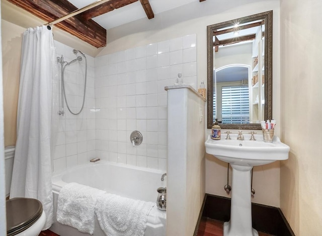 bathroom featuring toilet and shower / bath combo with shower curtain