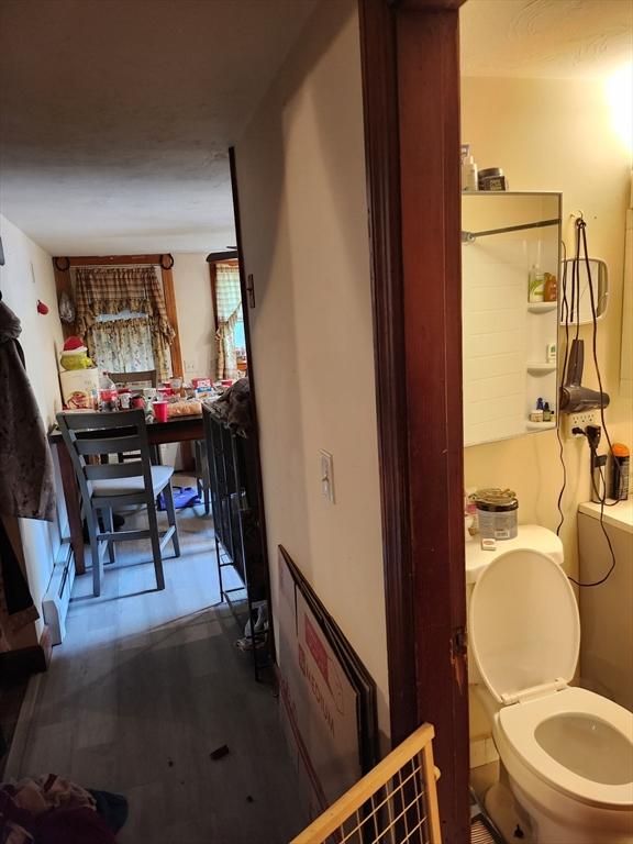 18 Pond St, Gardner, MA 01440 - bathroom featuring wood finished floors and a baseboard heating unit