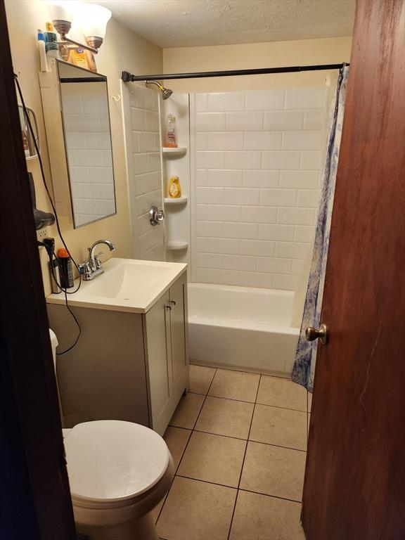18 Pond St, Gardner, MA 01440 - full bath featuring tile patterned flooring, shower / bath combination with curtain, vanity, and a textured ceiling