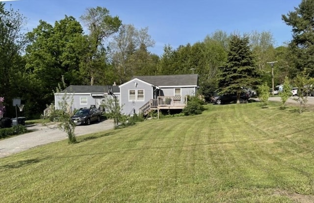 exterior space with a front yard and a wooden deck