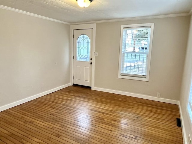 entryway featuring wood-type flooring and ornamental molding