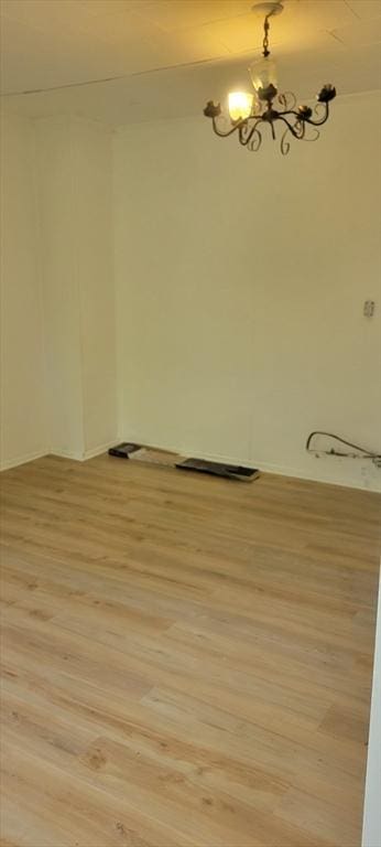 1 Barber Ave, Greenfield, MA 01301 - spare room featuring light wood-style flooring, a chandelier, and baseboards