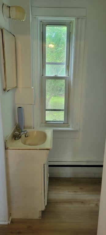 1 Barber Ave, Greenfield, MA 01301 - bathroom featuring vanity, a baseboard heating unit, and wood finished floors