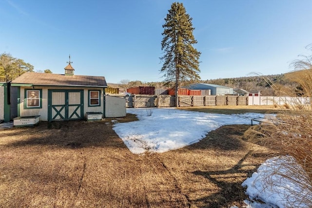 view of yard with an outbuilding, a storage unit, and fence