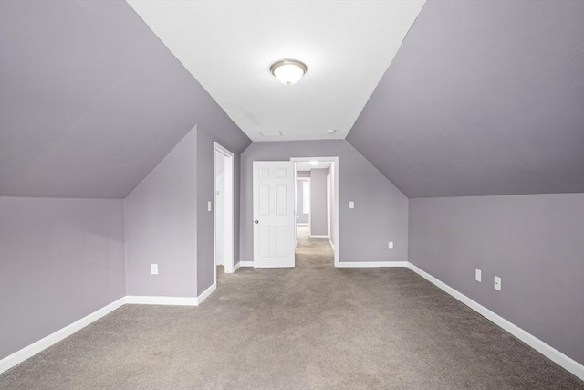 bonus room featuring light colored carpet and lofted ceiling