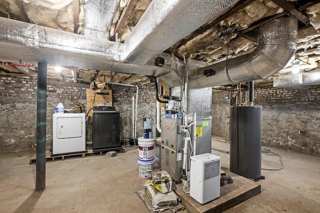 utility room featuring washing machine and clothes dryer and gas water heater