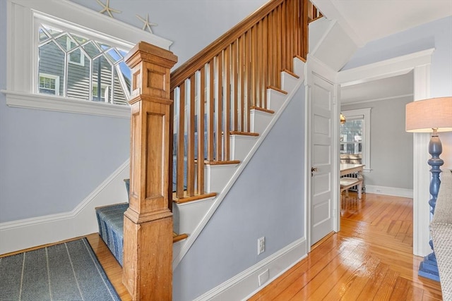 stairs featuring baseboards and hardwood / wood-style floors