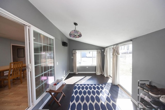 entryway featuring baseboards, dark wood-style floors, and vaulted ceiling