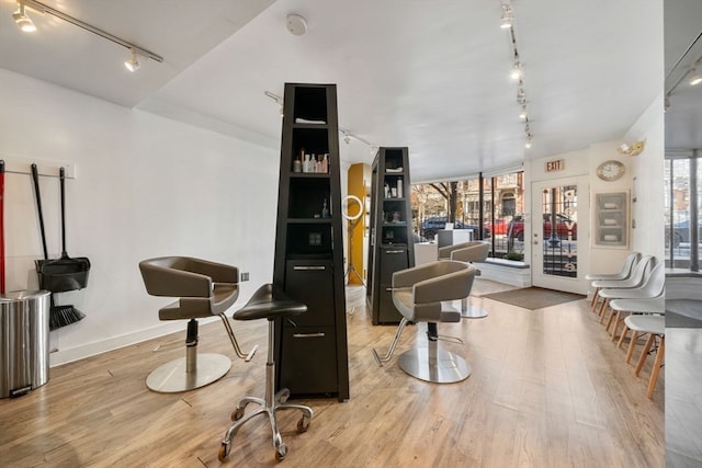 interior space featuring rail lighting and light hardwood / wood-style floors