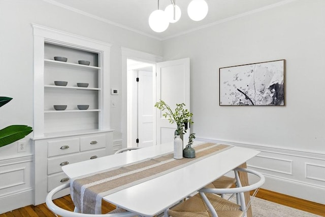 88 Brush Hill Rd, Milton, MA 02186 - office area featuring crown molding, wood finished floors, wainscoting, built in shelves, and a decorative wall